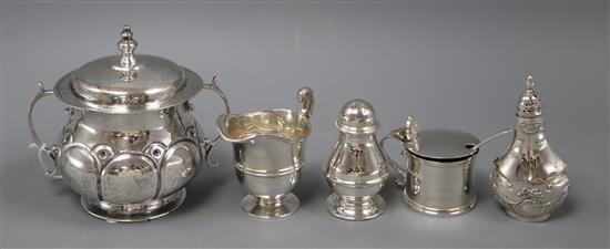 A late Victorian silver cream jug, a silver two handled porringer and three silver condiments.